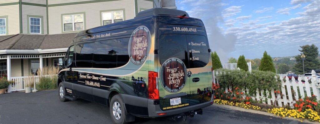 The Troyer's Amish Tours van in front of the Carlisle Inn-Walnut Creek