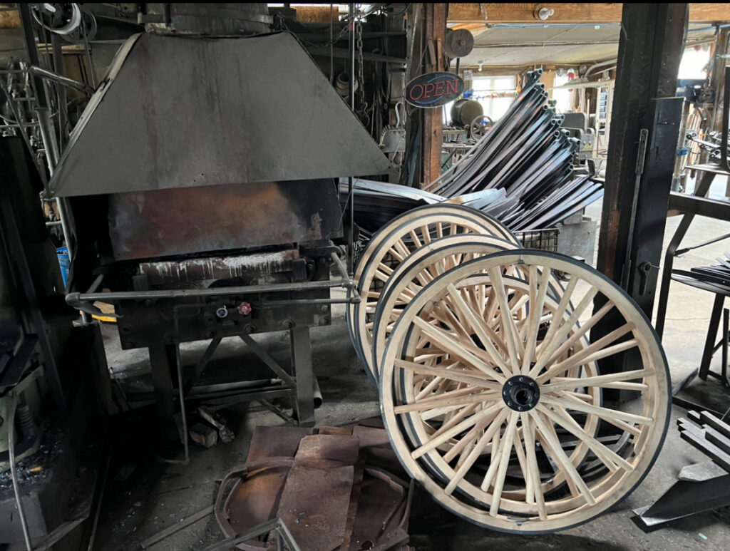 Buggy wheels and springs beside the blast furnace at the buggy manufacturer